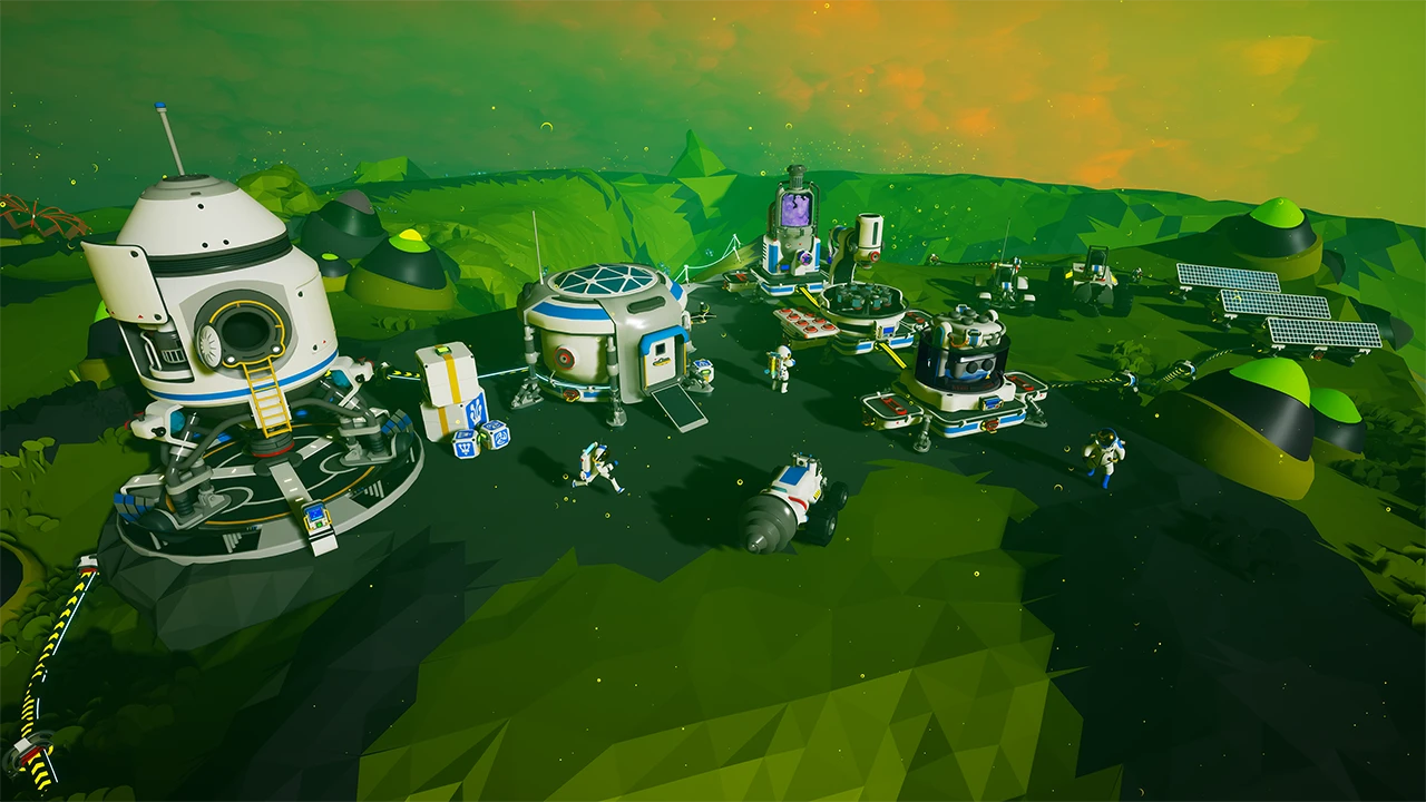 A colorful, stylized space base on a green alien planet in Astroneer, featuring modular habitats, vehicles, and small astronaut characters.