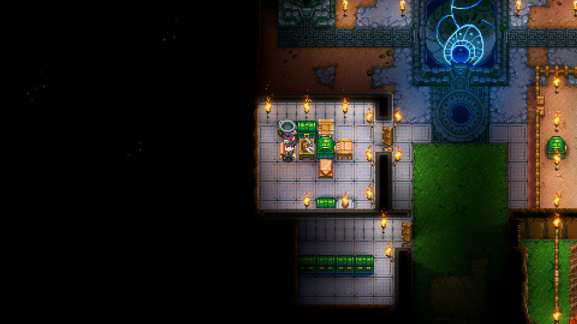 An overhead view of a Core Keeper base shows a player standing in a well-lit crafting room, filled with various workbenches, chests for storage, and torches.