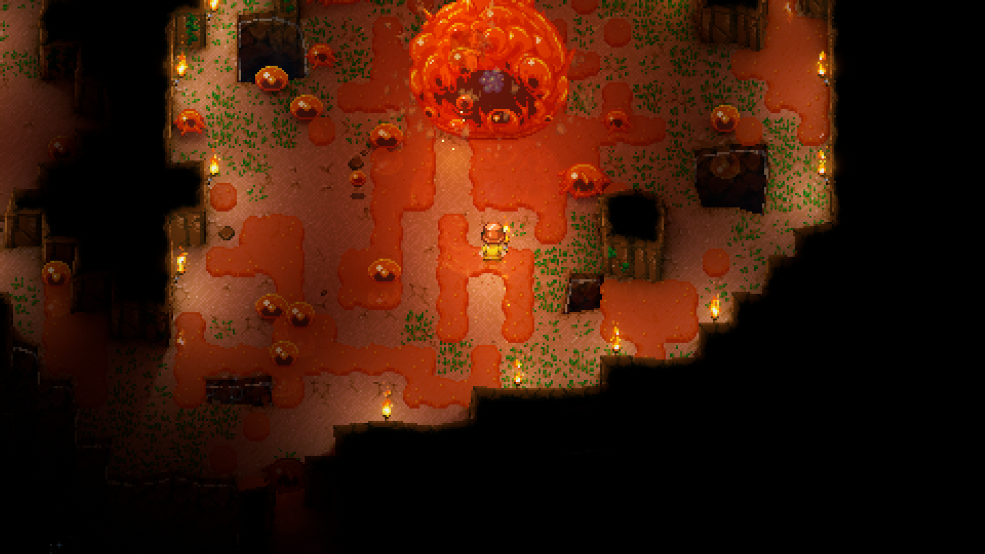 A screenshot from the game Core Keeper shows a player character facing Glurch the Abominous Mass. The area is lit by many small torches placed on the dirt ground and along the edges of the visible cavern. Parts of the cave walls and floor are dark, indicating unlit areas.