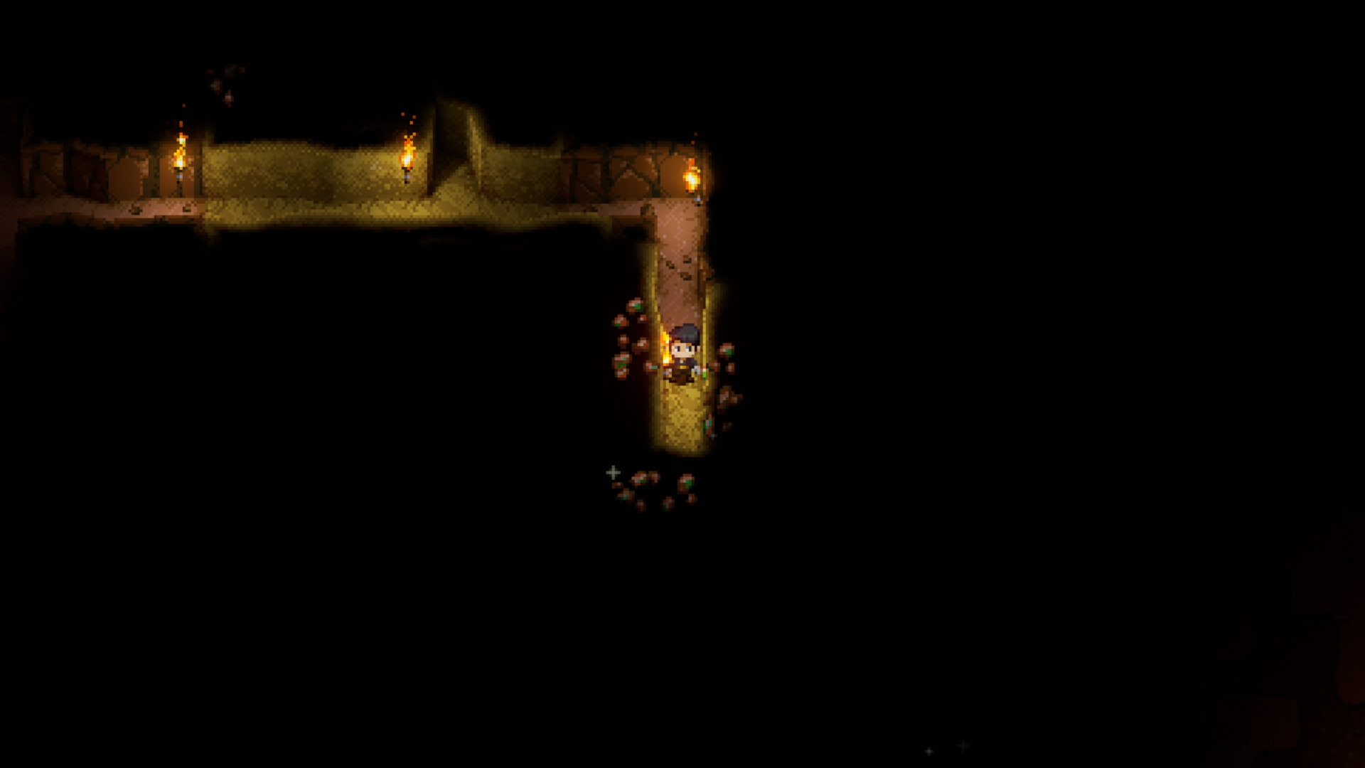 A Core Keeper player stands in a dark, excavated tunnel illuminated by torches, with patches of sparkling copper ore visible on the surrounding walls, ready to be mined.