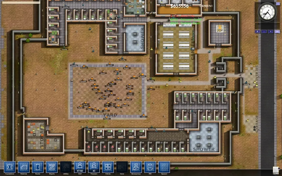A top-down screenshot of a large, complex prison layout in Prison Architect. The facility features numerous cell blocks, communal areas like a yard and showers, a kitchen, workshops, and various utility rooms, with tiny prisoner and guard figures moving throughout the stylized environment.